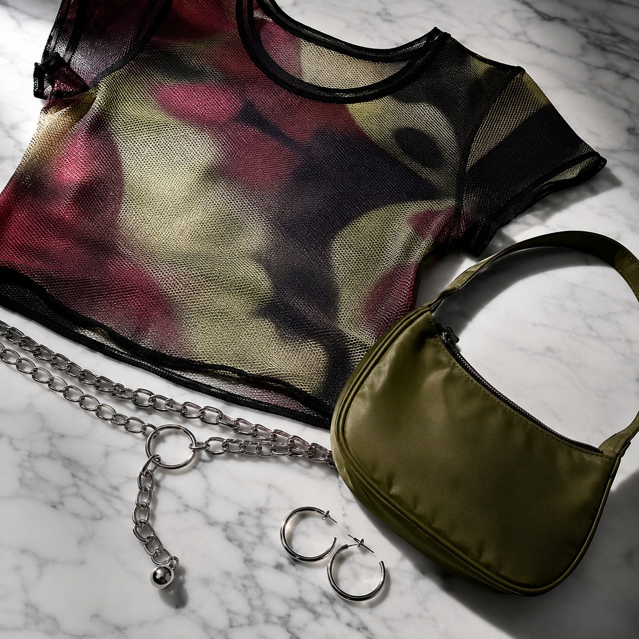 Smoky mesh top with silver chain belt and olive baguette bag styled as night-out 90s retro outfit inspiration