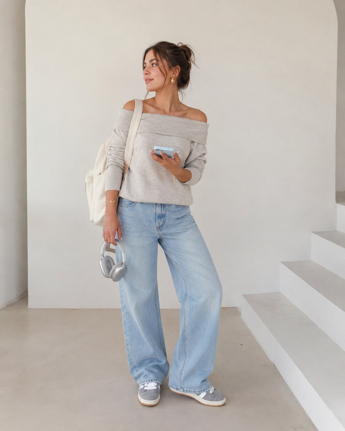 Off-shoulder grey knit sweater styled as a relaxed clean girl outfit idea with light wide-leg jeans