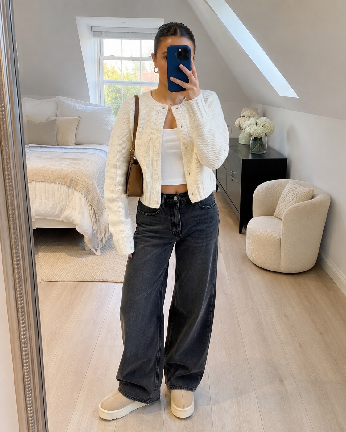 Cropped white cardigan over a cami with dark wide jeans, a mirror-selfie clean girl outfit idea