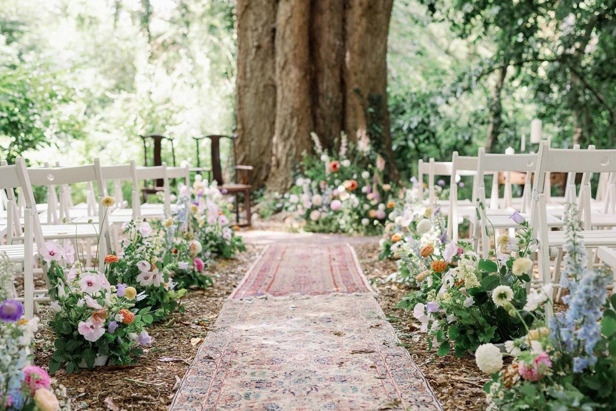 Floral decorated backyard wedding aisle