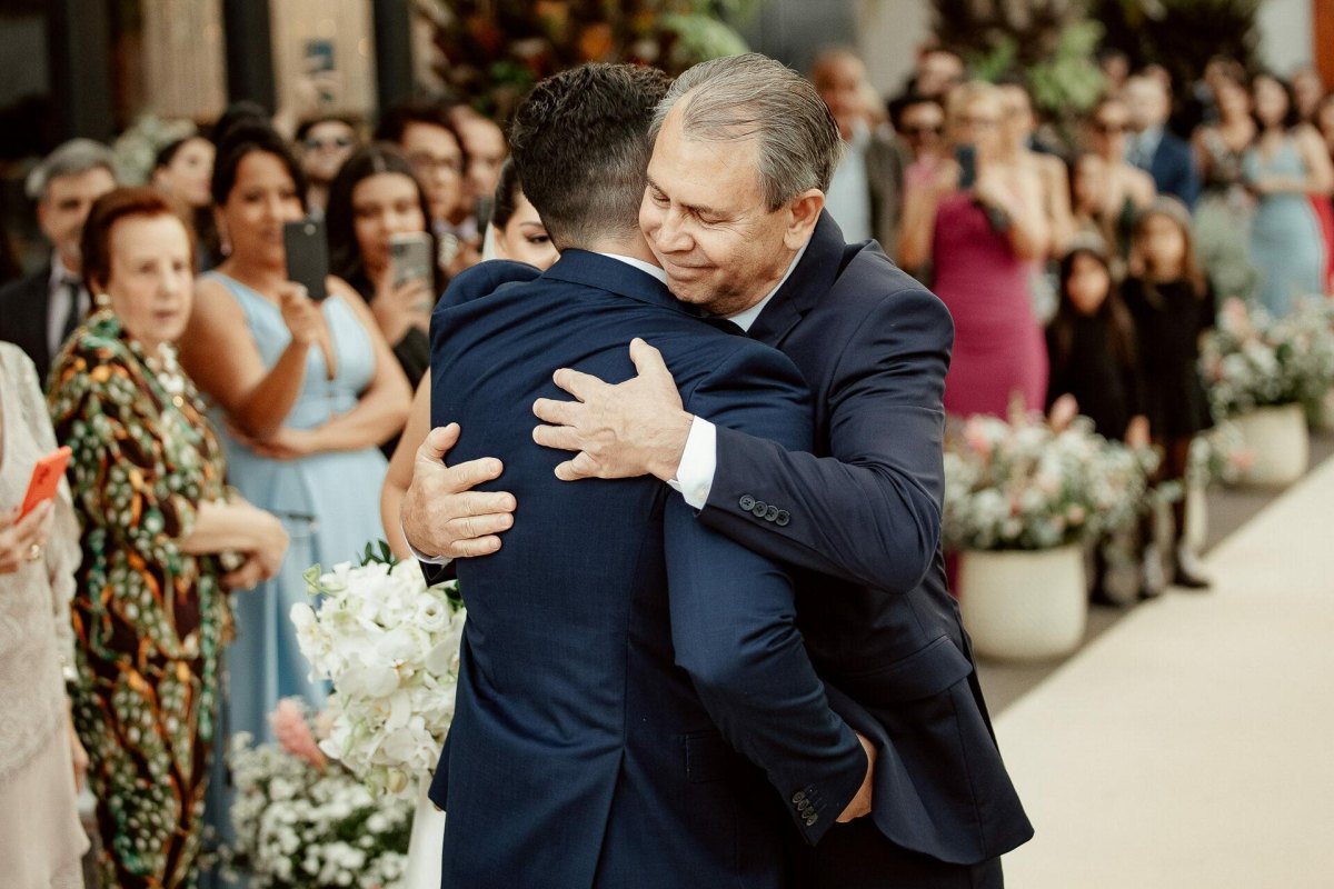 Father hugging son on wedding day