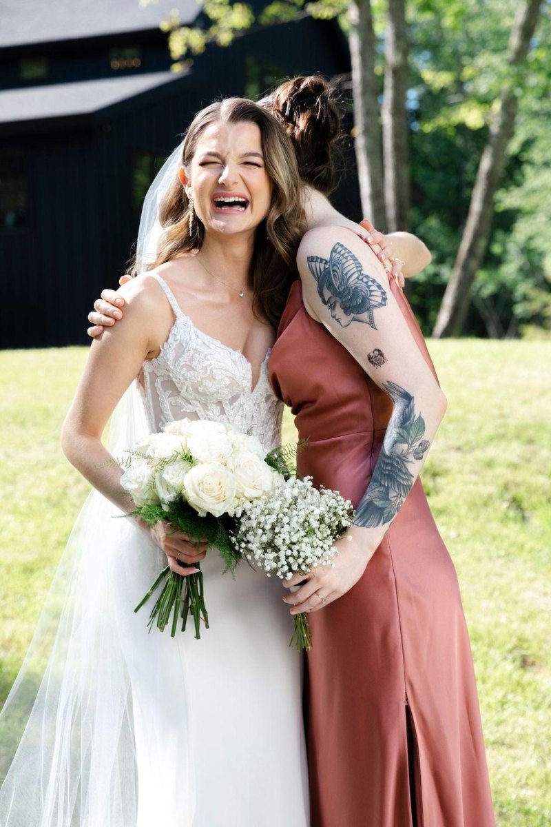 Bride hugging bridesmaid emotionally