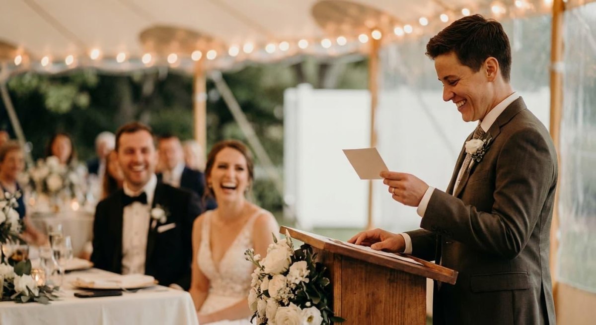 Guests laughing during wedding toast