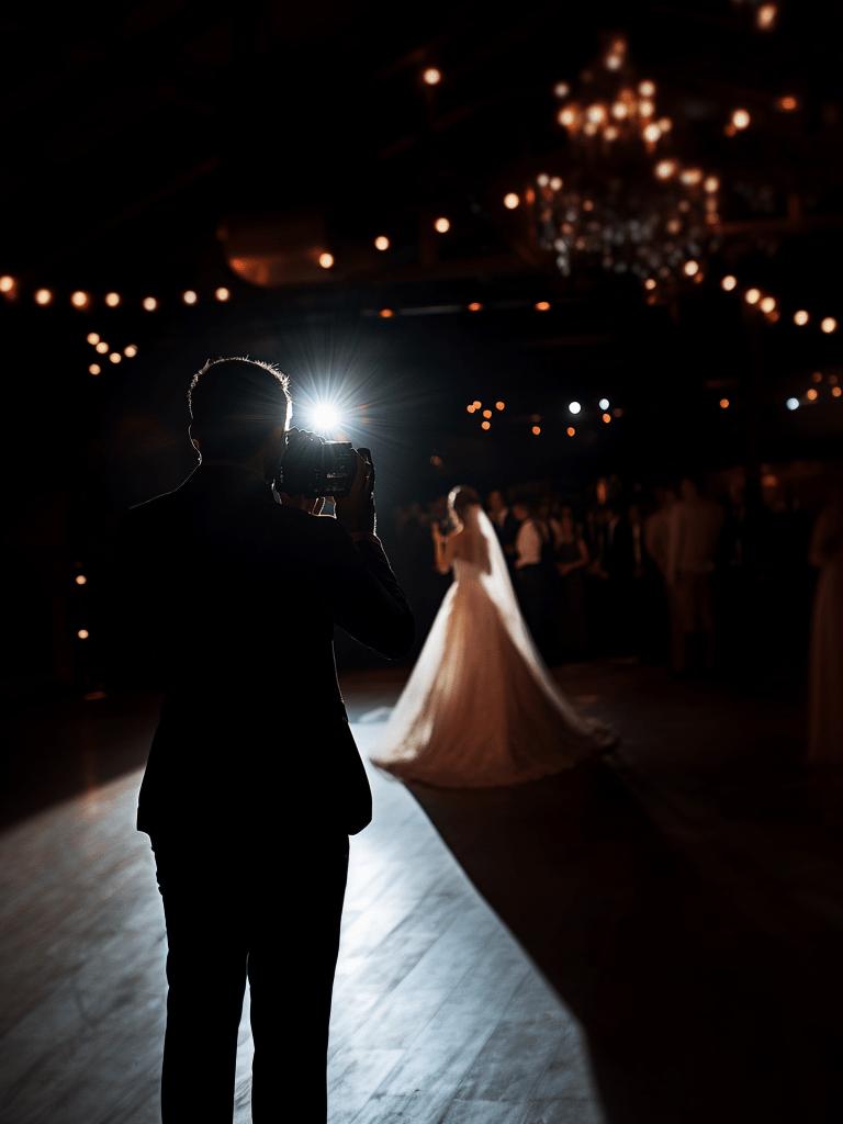 Wedding photographer taking a reception dance photo in low light
