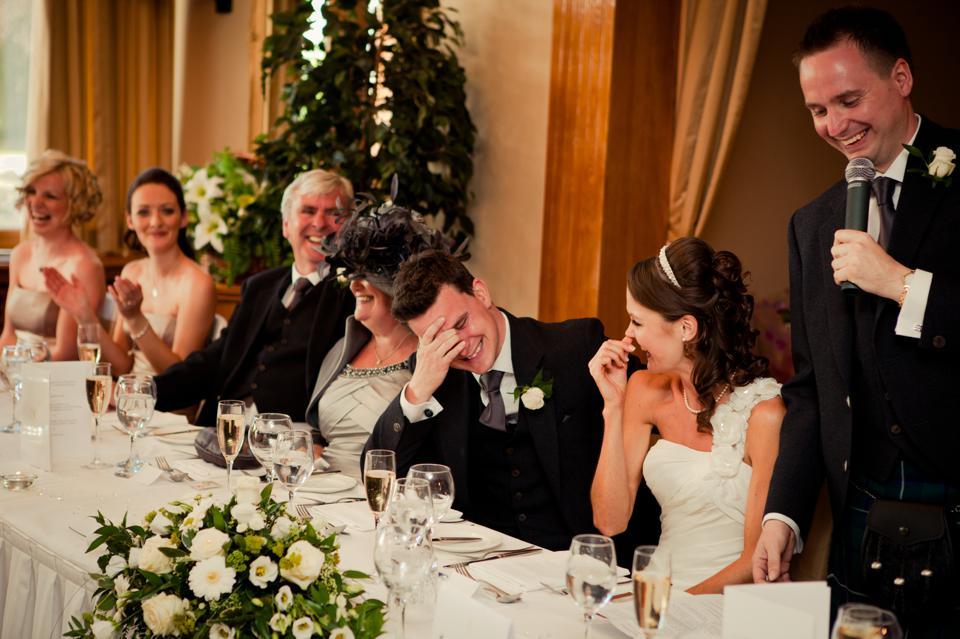 Wedding guests laughing during toast