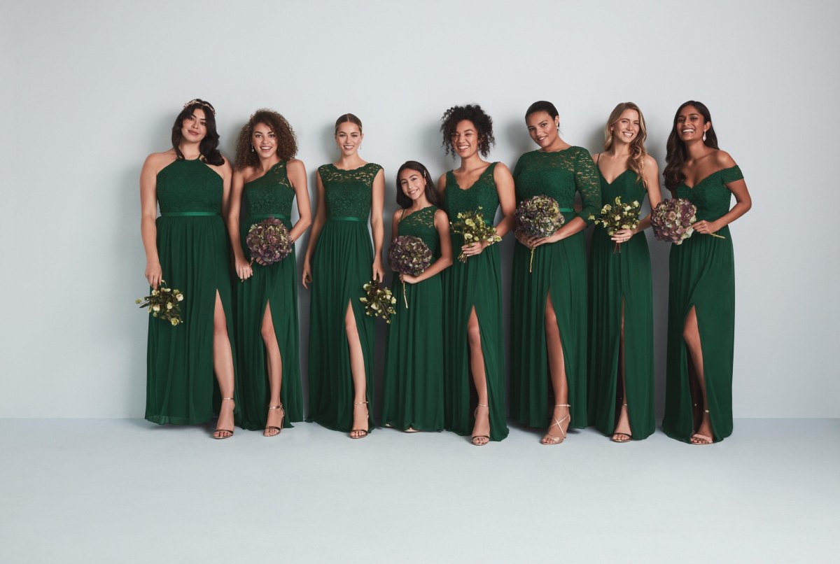 Bridesmaids wearing coordinated mix and match green dresses