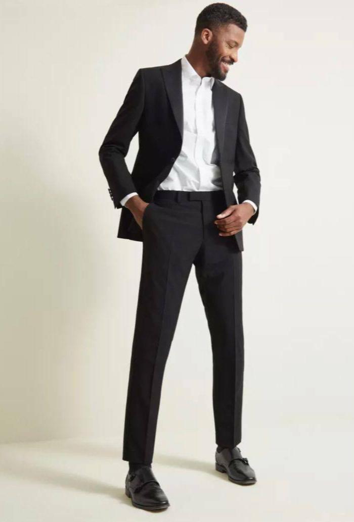 Black suit white accents wedding guest