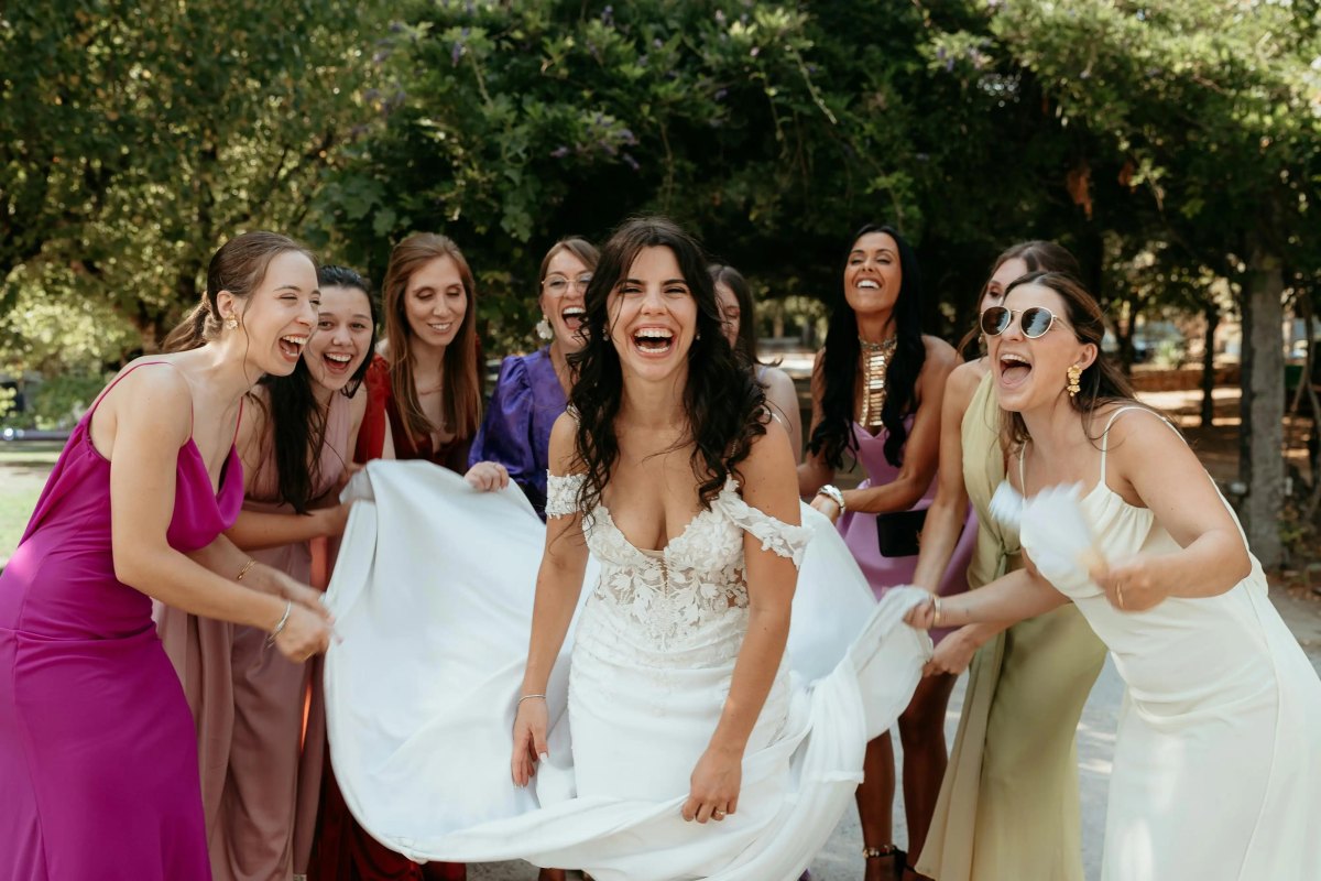 Bride laughing with bridesmaids