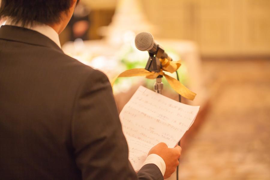 Person practicing wedding speech notes