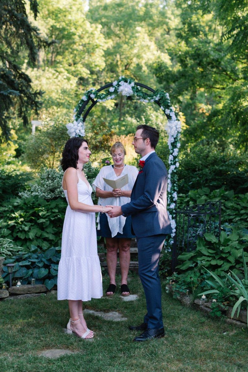 Couple exchanging vows in backyard
