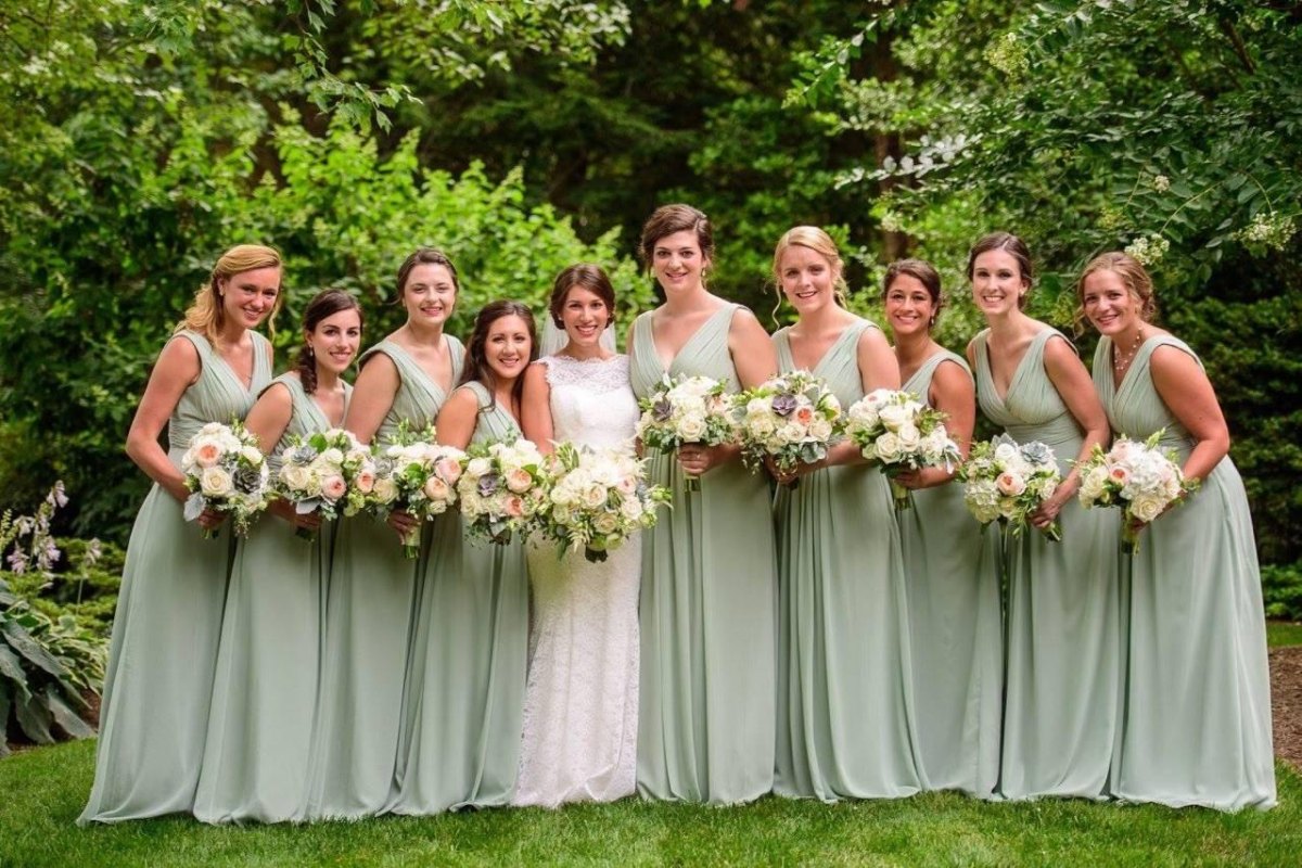 Sage green bridesmaid dresses at an outdoor wedding