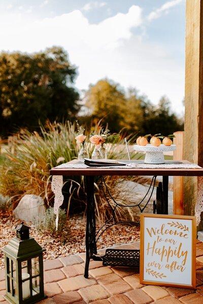 Seasonal backyard wedding welcome decor