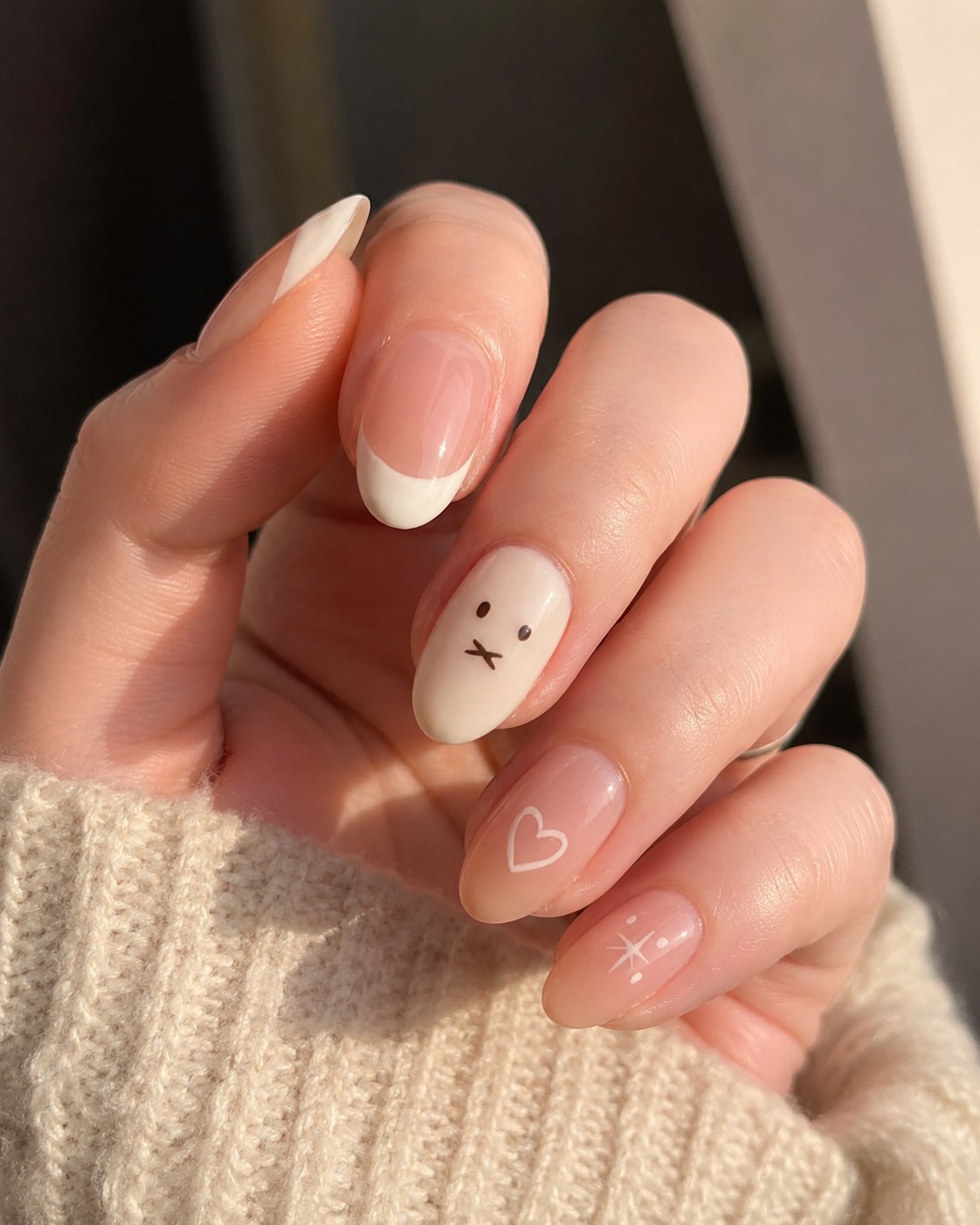 Short summer nails in a milky French manicure with a hand-drawn doodle accent nail