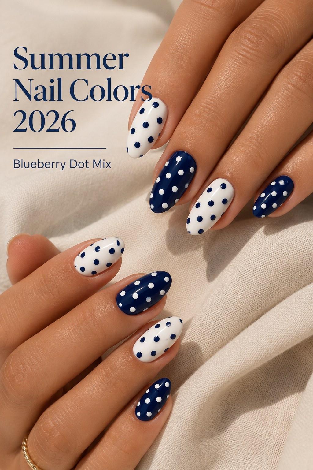 Blueberry dot mix nails in alternating navy and white polka dot nail art for summer 2026.