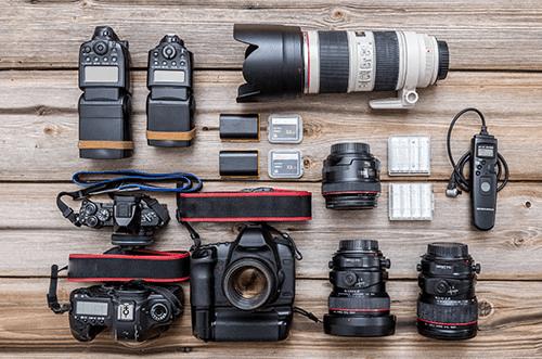 Wedding photographer camera gear arranged with professional equipment