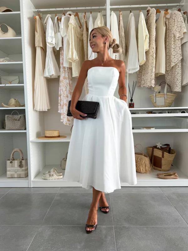 White dress black accessories wedding guest